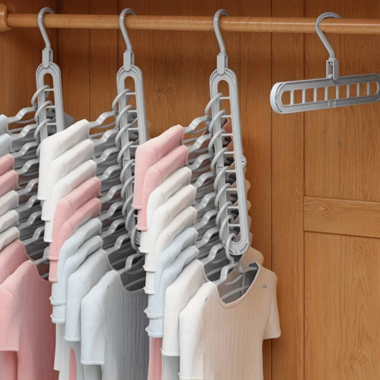 RosyIron space saver hanger cascading pink and white T-shirts in a wooden closet