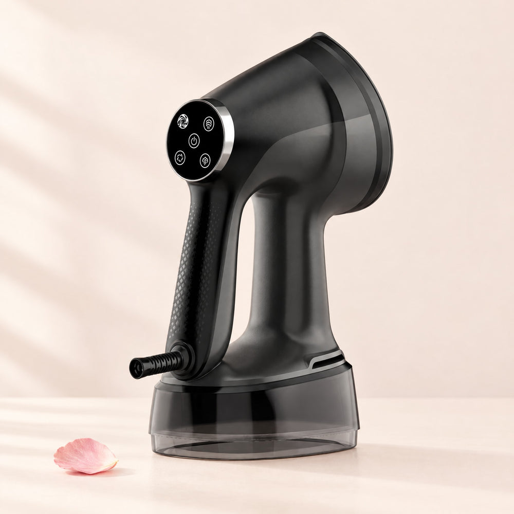 RosyIron handheld suction garment steamer in black standing upright on a blush studio backdrop