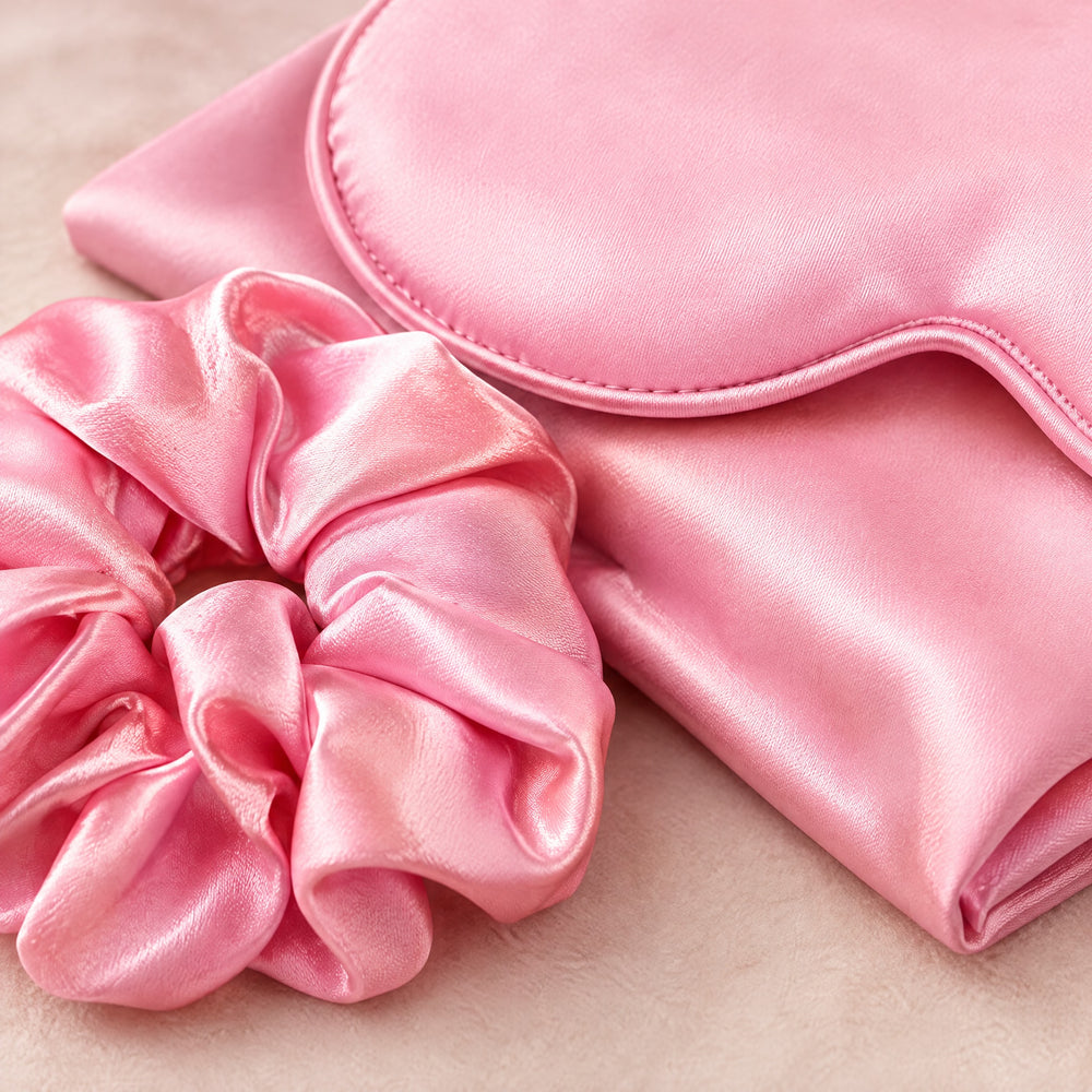 RosyIron close-up of the pink satin scrunchie and sleep mask piping showing the smooth sheen