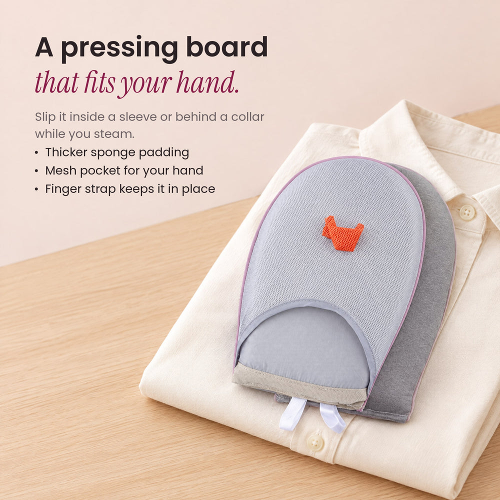 RosyIron garment steamer glove lying on a folded cream shirt, a padded pressing board that fits your hand