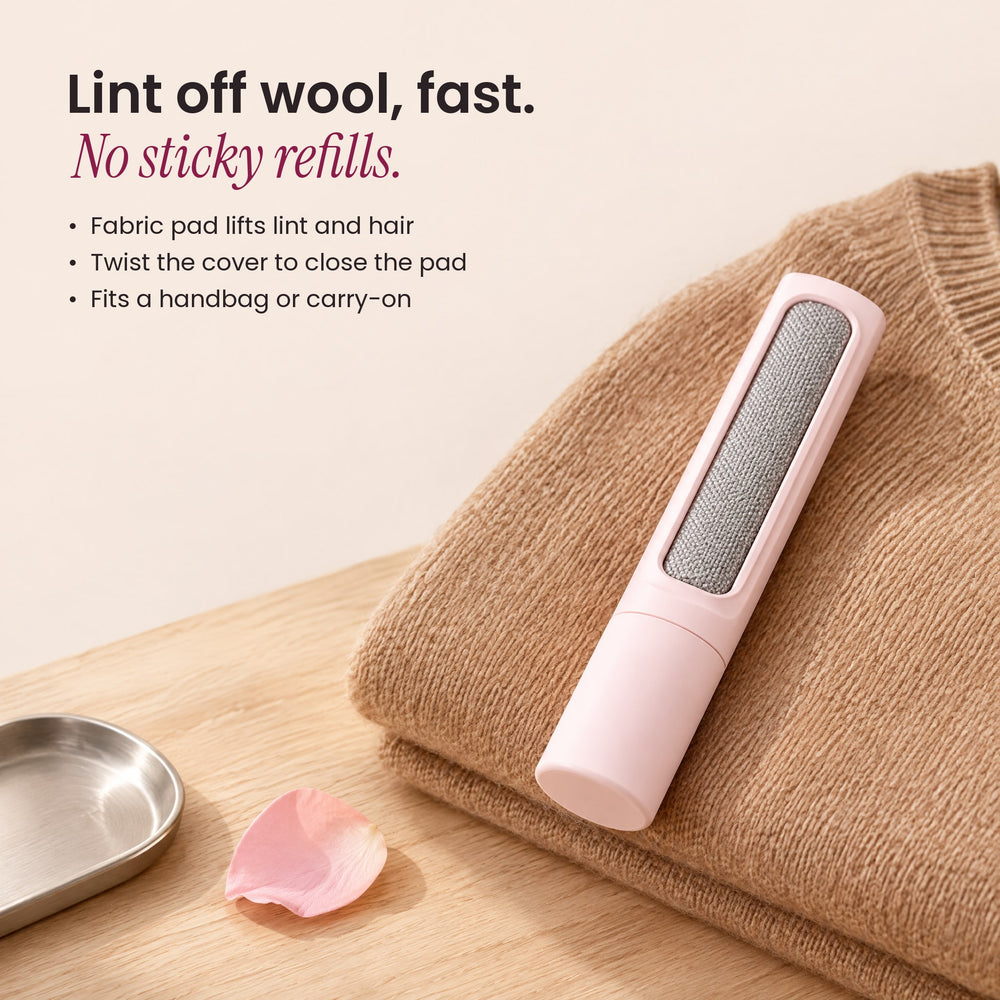 RosyIron pink lint brush resting on a folded camel wool sweater, with benefits: no sticky refills, twist cover
