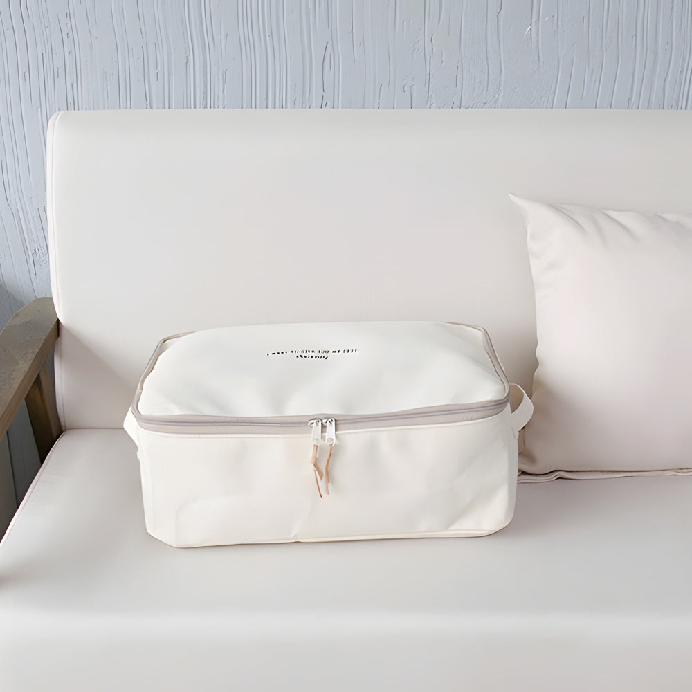 RosyIron cream canvas storage box with zipper lid resting on a light sofa