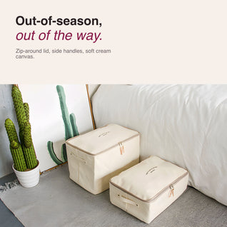 RosyIron canvas zippered storage boxes beside a bed for sweaters and bedding
