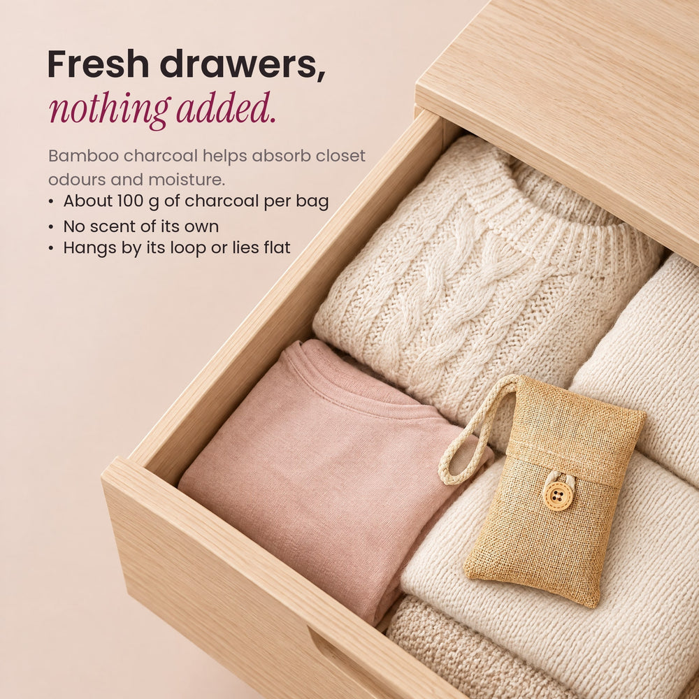 RosyIron bamboo charcoal bag lying on folded sweaters in an open wooden dresser drawer