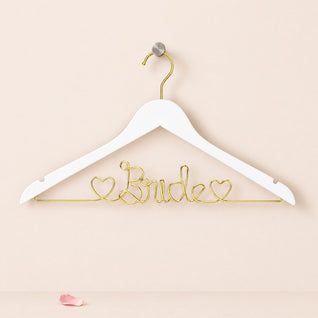 RosyIron Bride wedding dress hanger in white with gold wire Bride lettering and two hearts on a wall peg