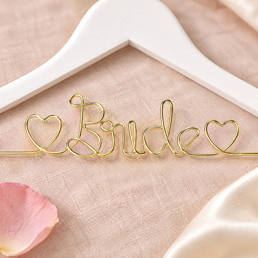 RosyIron Bride hanger close-up of the gold wire Bride lettering and small hearts on the white hanger