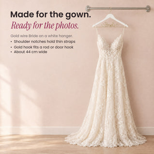 RosyIron Bride wedding dress hanger holding a lace wedding gown on a brushed silver wall rail