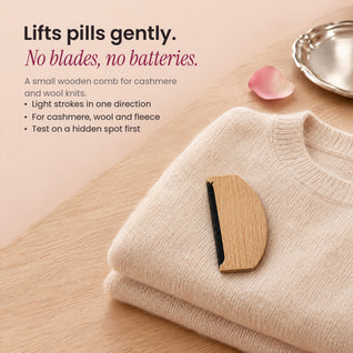 RosyIron sweater comb resting on a folded cream cashmere sweater, gentle pill removal without blades or batteries