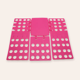 RosyIron adjustable clothes folding board in rose, opened flat with panels extended on a blush background