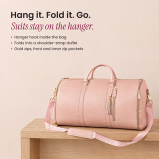 RosyIron convertible garment bag folded into a pink duffel on a wooden bench with its shoulder strap