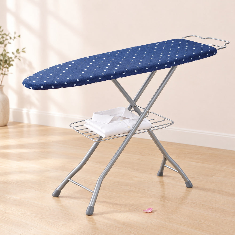 RosyIron ironing board with navy polka-dot cover, wire iron rest and a folded shirt on the storage tray