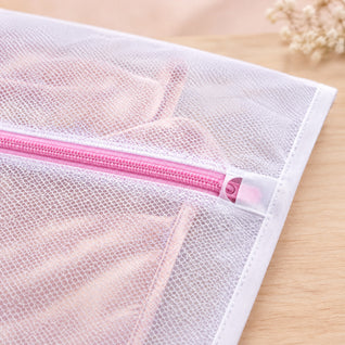RosyIron mesh laundry bag close-up showing the pink zipper, zipper guard pocket, bound edge and fine mesh