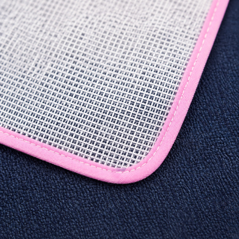 RosyIron pressing cloth close-up showing the fine see-through mesh and stitched pink binding on navy wool