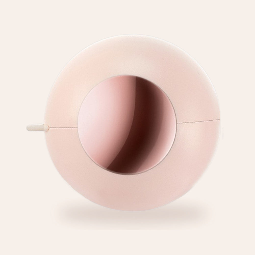 RosyIron reusable gel lint roller ball in blush pink with mirror window, on a soft cream background