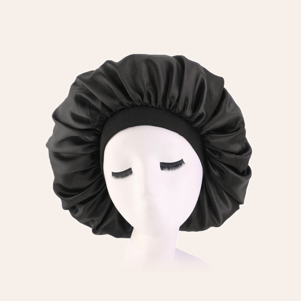 RosyIron satin sleep bonnet in black with a wide stretch band, shown on a display head