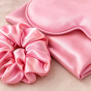 RosyIron close-up of the pink satin scrunchie and sleep mask piping showing the smooth sheen