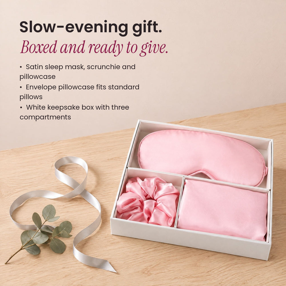 RosyIron Satin Sleep Gift Set boxed as a holiday gift with a silver ribbon on a wood table