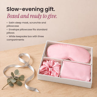 RosyIron Satin Sleep Gift Set boxed as a holiday gift with a silver ribbon on a wood table