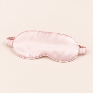 RosyIron satin sleep mask in blush pink with thin piping and gathered elastic strap on a blush-cream backdrop