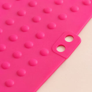 RosyIron heat resistant silicone mat close-up showing the raised silicone dots and the tab with two holes