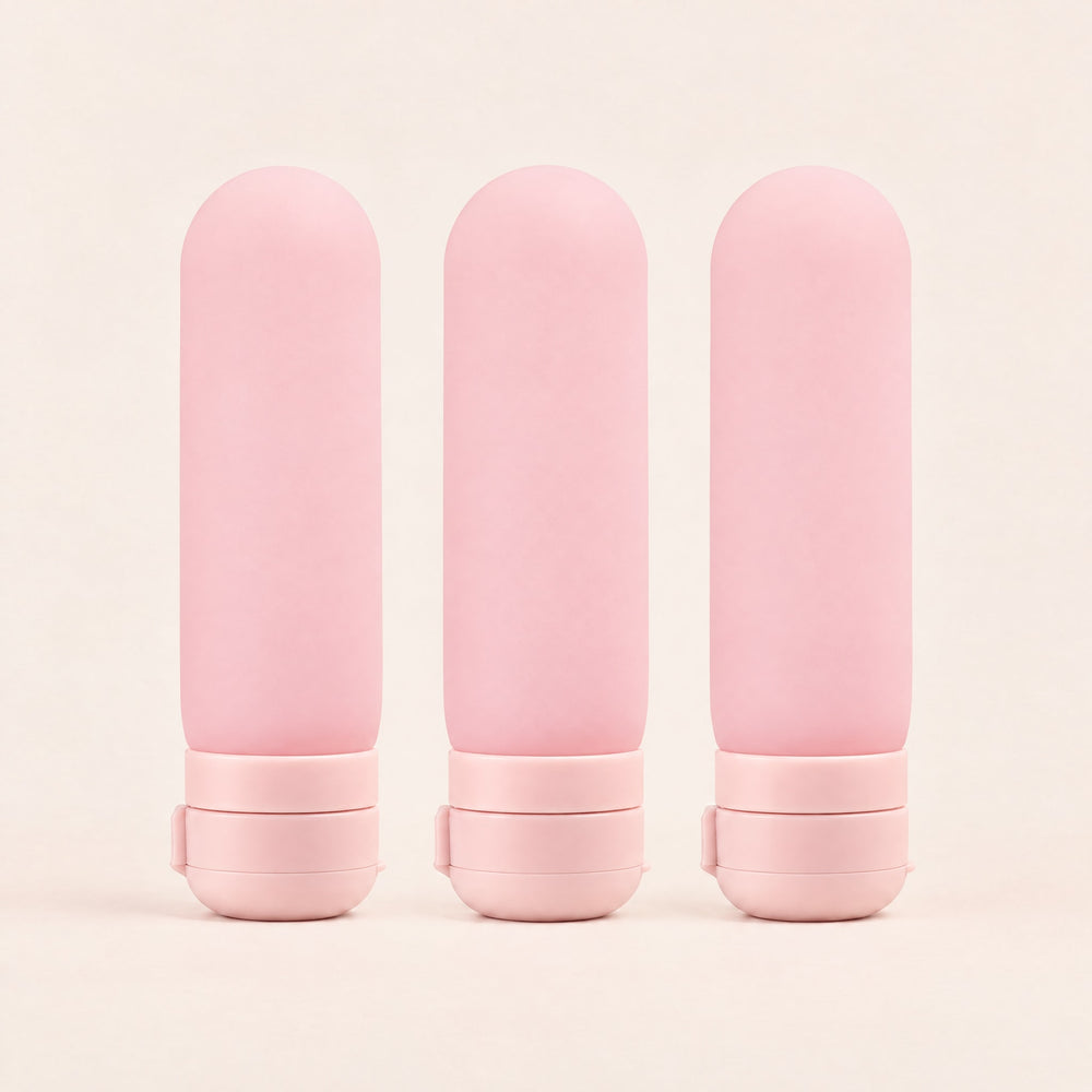 RosyIron silicone travel bottles, set of 3 pink capsule bottles standing side by side on their flip-top caps