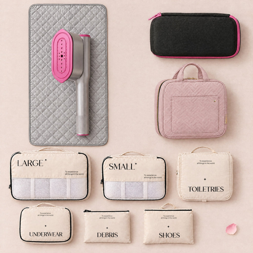 RosyIron Steam & Go Travel Set flat lay: SteamerPro on the rectangular ironing mat, travel case, pink toiletry bag and six packing cubes