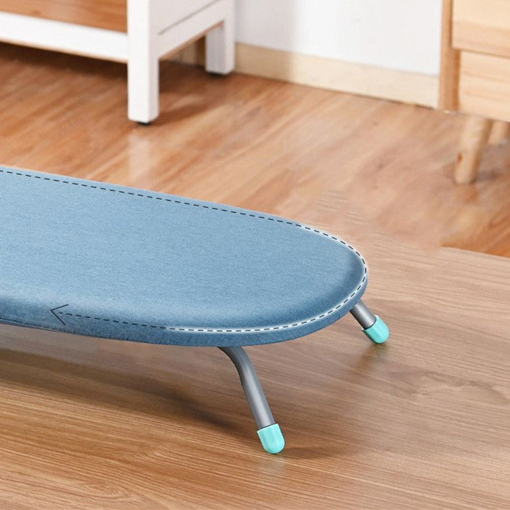 RosyIron tabletop ironing board close-up of the padded blue cover edge and grey steel legs