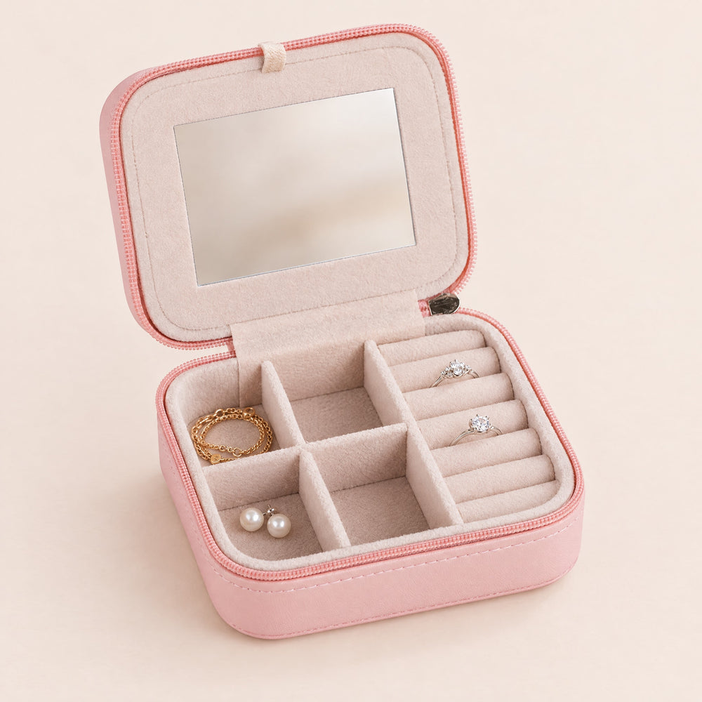 RosyIron mini travel jewelry case in blush pink, open with mirror lid, ring rolls and four velvet compartments