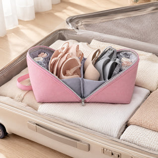 RosyIron pink lingerie pouch opened flat in a suitcase with bras nested cup-in-cup and rolled underwear