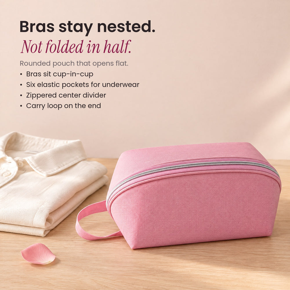 RosyIron travel lingerie bag in pink beside a folded cream shirt on a light wood surface